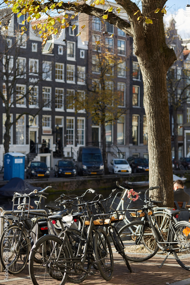 Bikes parked near an Amsterdam canal in autumn