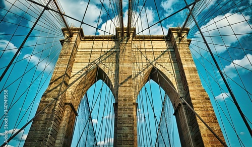 The Brooklyn Bridge, built in 1883, is one of the oldest suspension bridges in the United States. View from the pedestrian walkway straight up towards the tower.