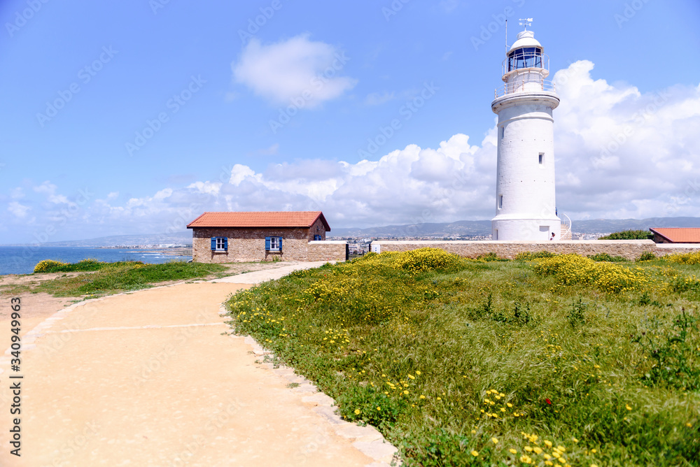 Lighthouse white against the blue sky. Symbol of hope and faith in the future Lighthouse white against the blue sky. Symbol of hope and faith in the future