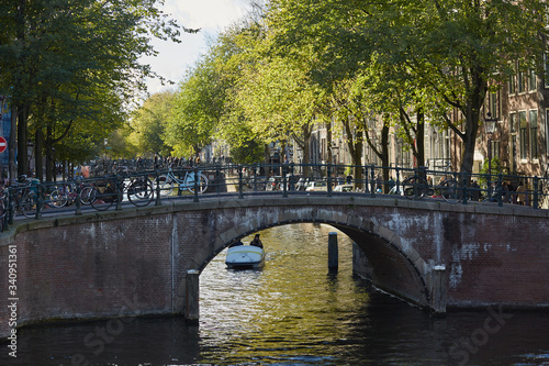 A bridge over an Amsterdam canal with bikes parked