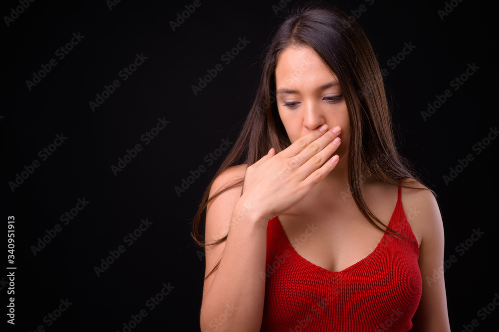 Young multi ethnic beautiful woman against black background