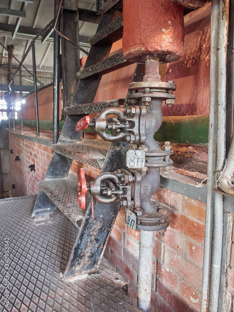Valves of the operating steam boiler in the boiler house.