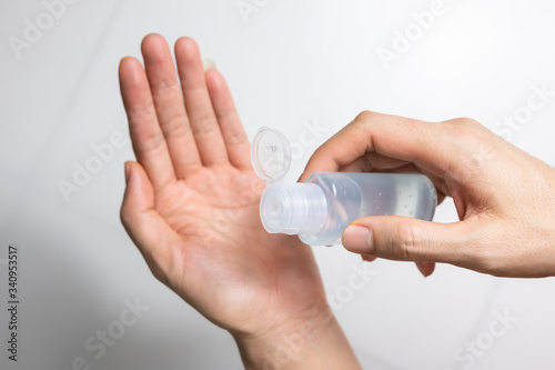 Man using alcohol gel, hand sanitizer gel for protection coronavirus disease (covid-19) and germ (select focus)