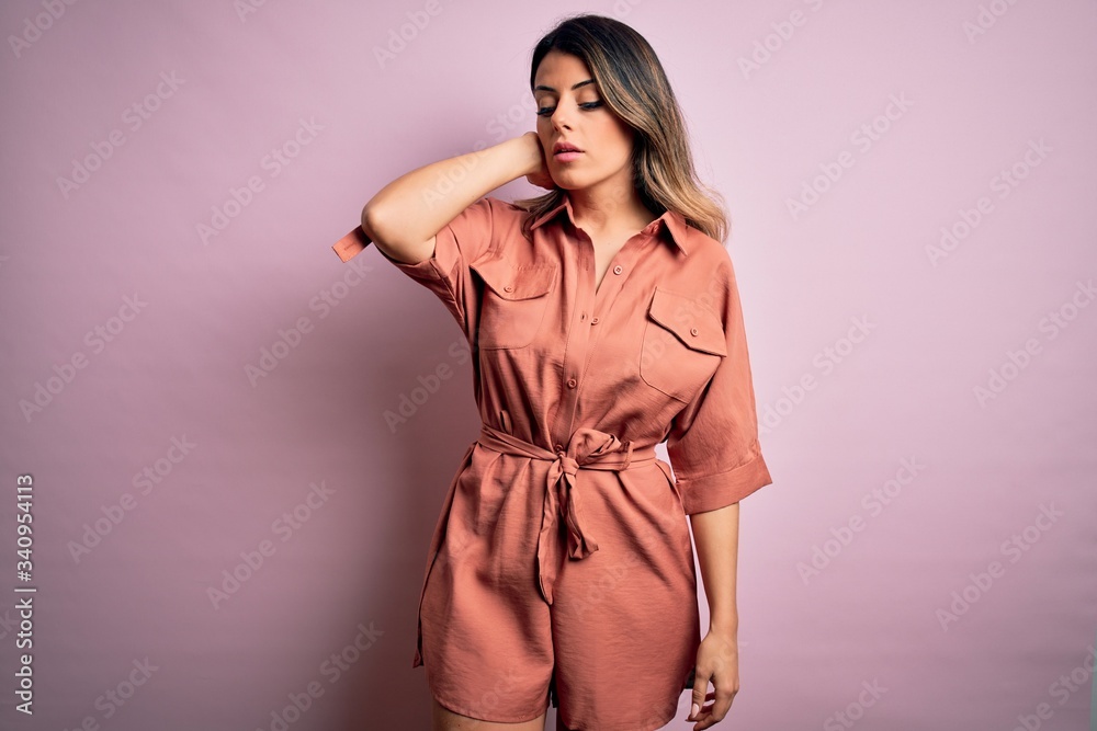 Young beautiful woman wearing fashion urban clothes, model wearing casual street style standing over pink background Young beautiful woman wearing fashion urban clothes, model wearing casual street style standing over pink background