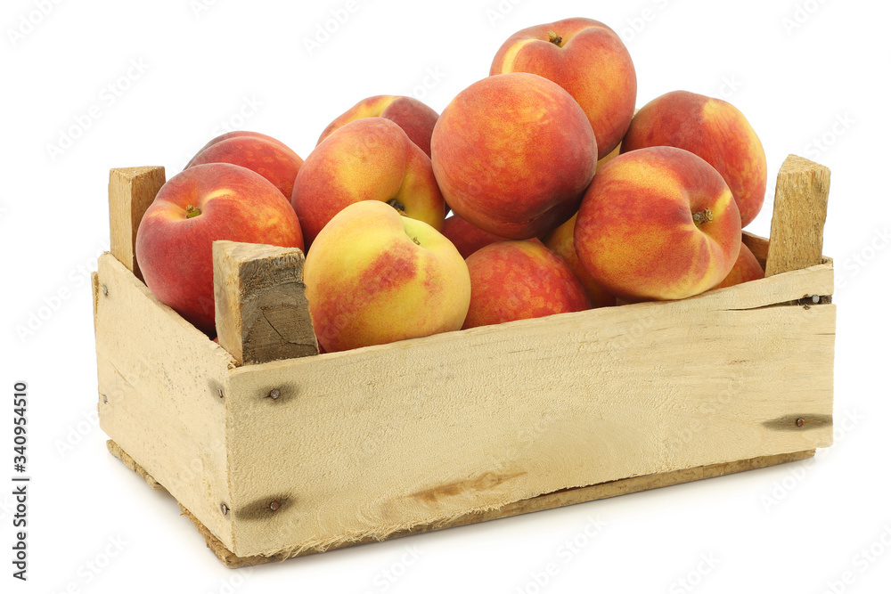 Fresh peaches in a wooden crate on a white background Fresh peaches in a wooden crate on a white background