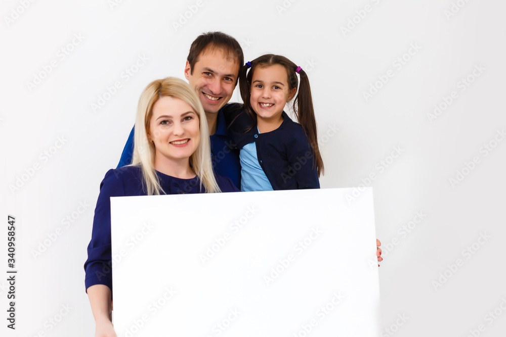 family holds holds a large photo canvas