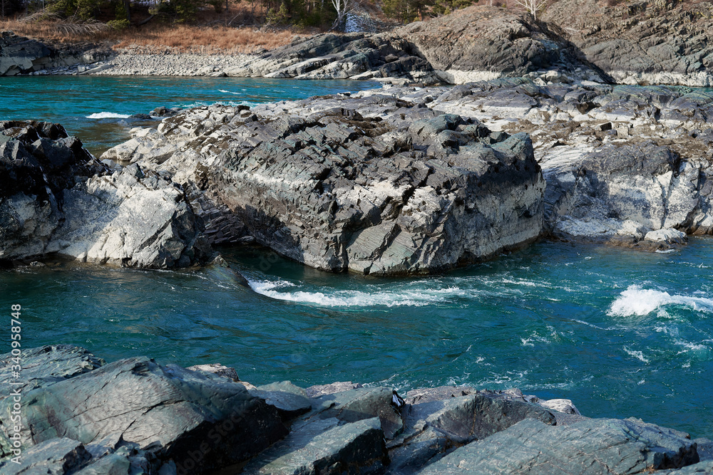 Emerald water of mountains river vith rocks. Bubbling stream of river Katun in Altai Republic