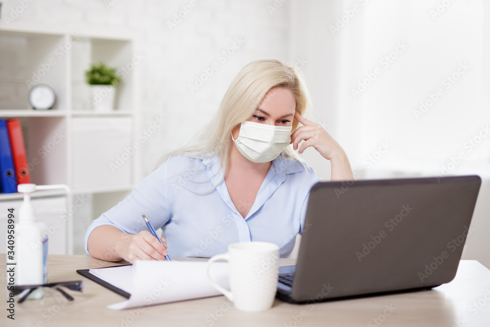 business, health care, safety and corona virus pandemic concept - woman in mask working with laptop at home or in office business, health care, safety and corona virus pandemic concept - woman in mask working with laptop at home or in office