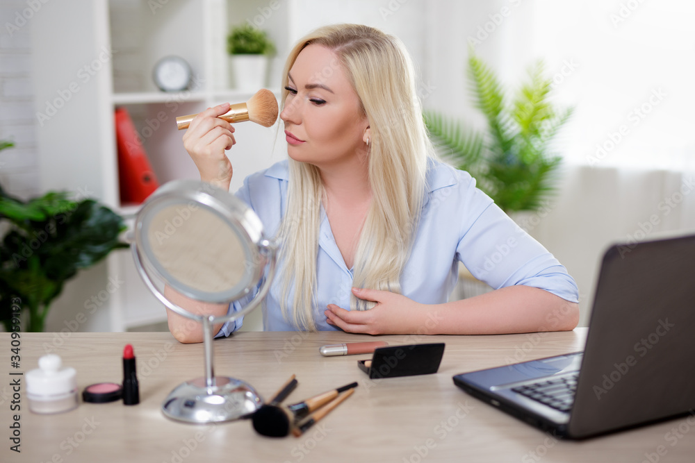 beautiful plus size blonde woman applying make up at home beautiful plus size blonde woman applying make up at home