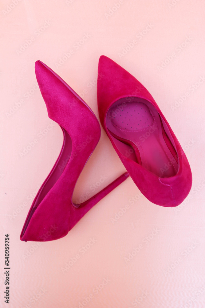 pink high-heeled shoes on a peach background pink high-heeled shoes on a peach background