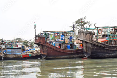 A harbor of different sized wooden fishing boat,where the boats are grounded safely © FinestWebGeek