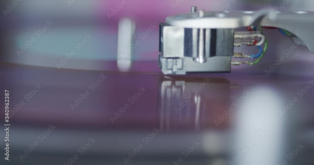 Gramophone needle stylus close-up - producing analog sound from plastic vinyl record