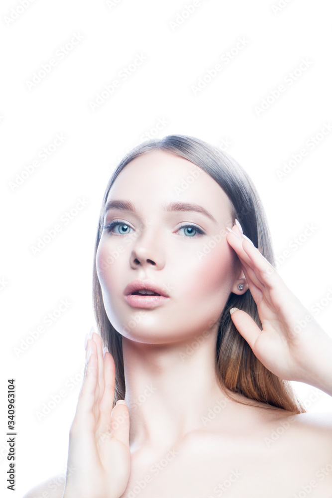 Fototapeta premium Beautiful model girl face apply facial treatment with hands. Healthy skin, natural make-up. White background