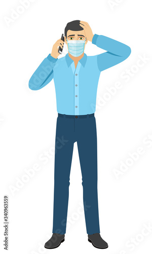 The man in medical mask talking on the mobile phone and grabbed his head. Full length portrait of man in a flat style.