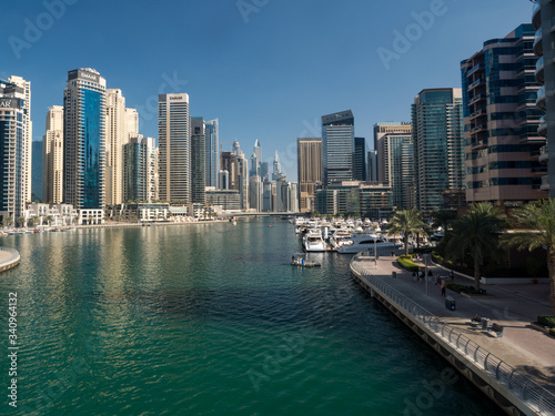 February 2020: Promenade and canal in Dubai Marina with luxury skyscrapers around,United Arab Emirates