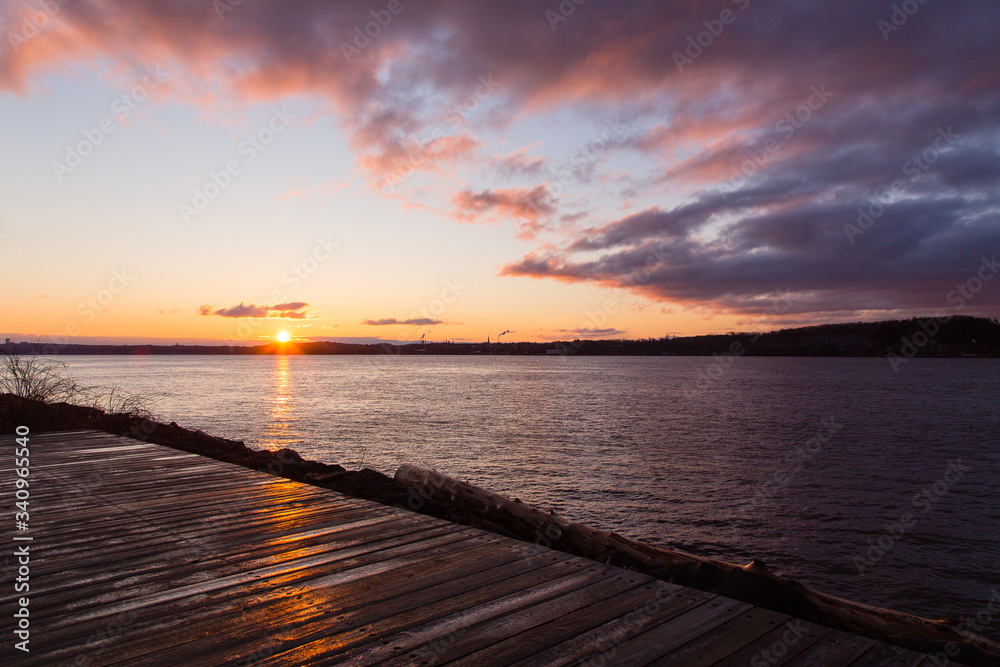 Beautiful sunrise over Lévis seen from the Champlain walk during a golden hour spring morning, Sillery area, Quebec City, Quebec, Canada Beautiful sunrise over Lévis seen from the Champlain walk during a golden hour spring morning, Sillery area, Quebec City, Quebec, Canada