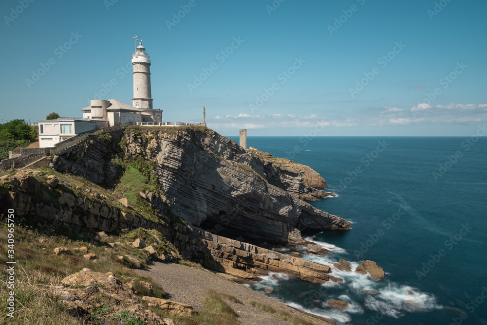 Scenic landscape of white lighthouse on cliff seashore of Costa Brava in sunny day Scenic landscape of white lighthouse on cliff seashore of Costa Brava in sunny day