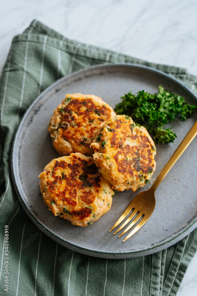 Healthy delicious grilled cutlets made from fish and vegetables served on metal plate with fork and garnished with broccoli Healthy delicious grilled cutlets made from fish and vegetables served on metal plate with fork and garnished with broccoli