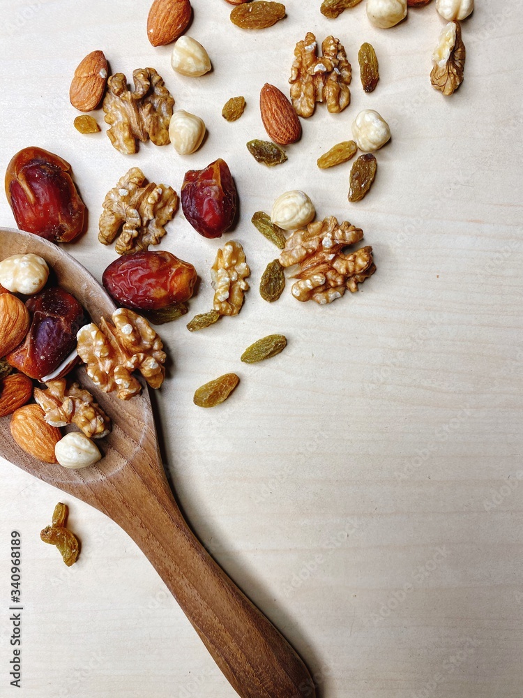 Nutty background, dates, walnuts, almonds, hazelnuts, raisins.