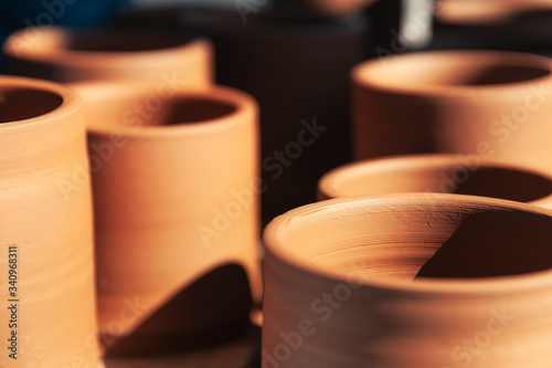 Closeup set of traditional clay pots placed on table in pottery photo