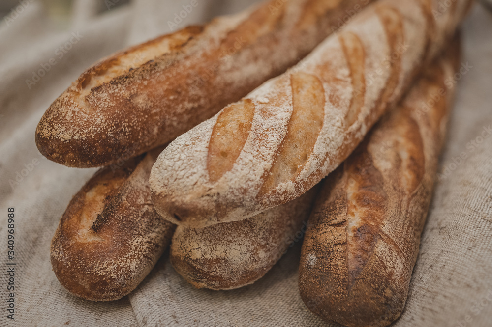 Buckwheat baguettes in baker's hands. Gluten free