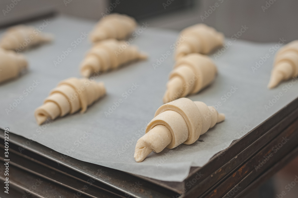 The process of making croissants in a bakery.