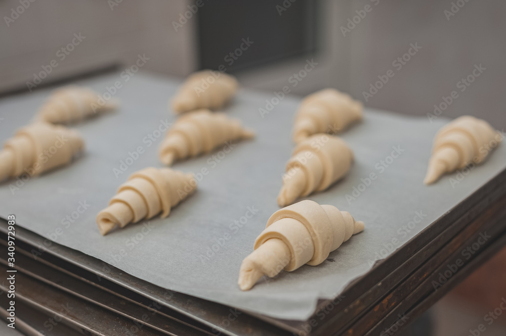 The process of making croissants in a bakery.