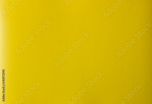 Bright colorful yellow color cardboard texture.