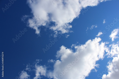 Background bright blue sky in white clouds