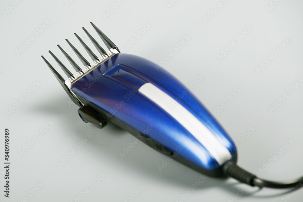 blue hair clipper on a gray background