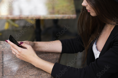 A woman holding a cell phone. High quality photo