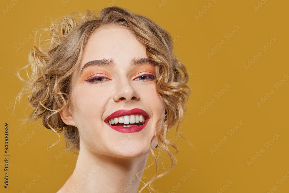 Happy smiling woman on bright yellow background, beautiful face close up Happy smiling woman on bright yellow background, beautiful face close up