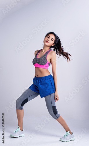 Young beautiful lady wearing sportwear,standing feet apartse kneel and turn face up,dance workout for exercise,with happy feeling