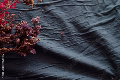 Dried flowers put at the lefft side on grunge surface background,vintage and art tone,classic style photo