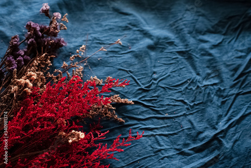 Dried flowers put at the lefft side on grunge surface background,vintage and art tone,classic style,blurry light around photo