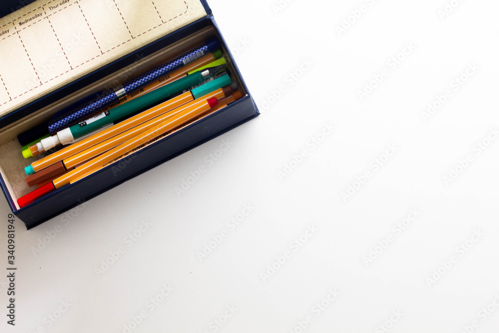 Fototapeta premium Pen case with notepad and stickers on a white background, mockup 