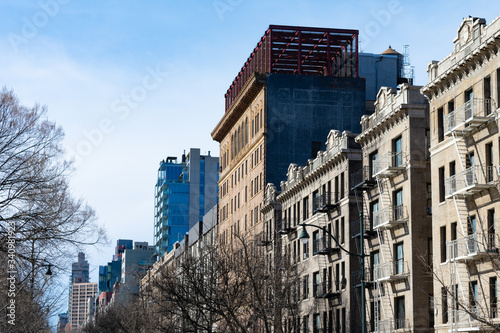 Row of Old Residential Buildings with Fire Escapes in Harlem of New York City