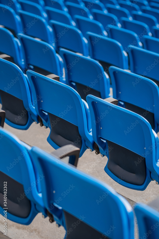 Fototapeta premium empty stadium chairs - games without fans