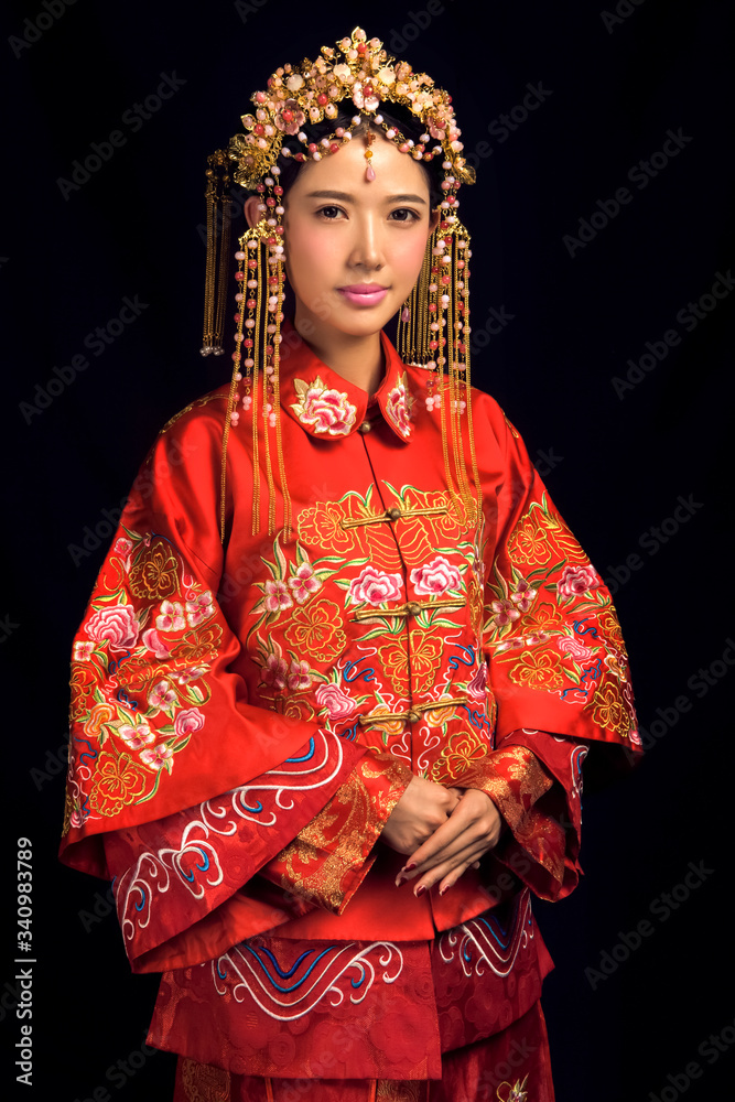Asian girls in ancient bridal costumes on a black background