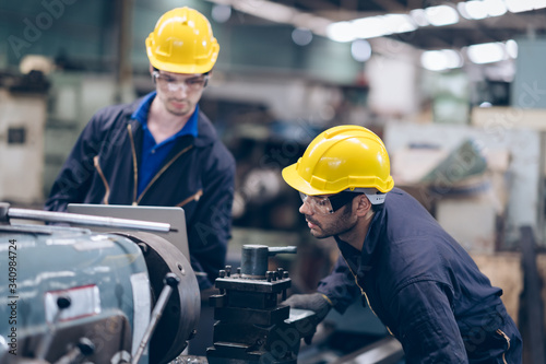 Two worker in production line as working at heavy machine