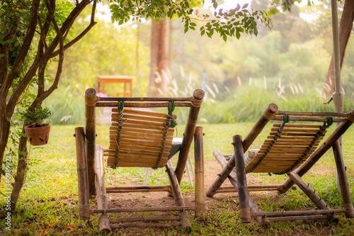 Two classic bamboo chair in the garden with warm sunlight