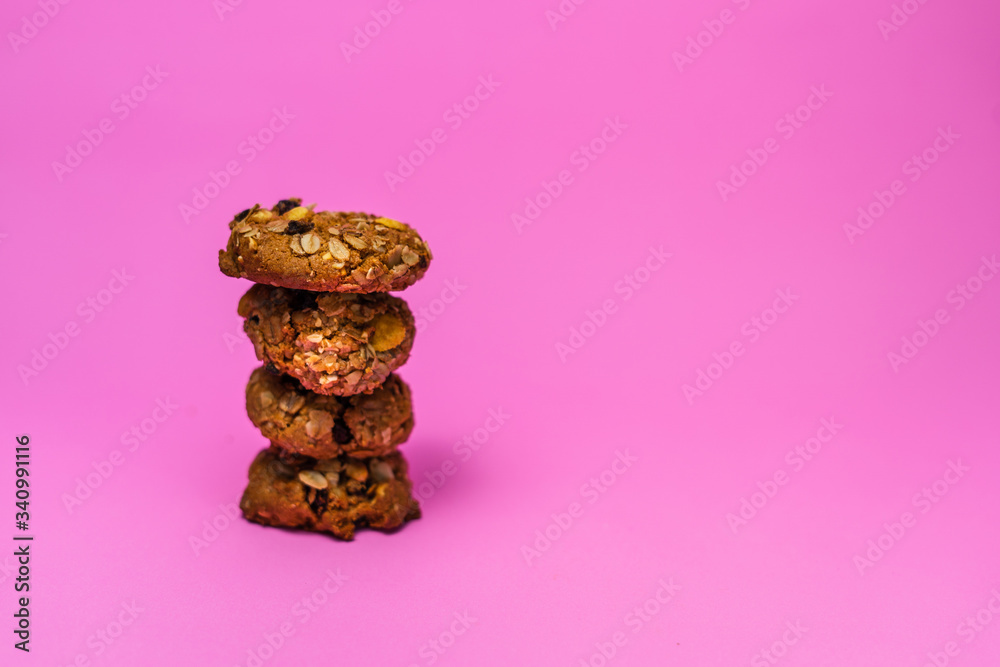 Cereal, chocolate, cookies and milk in a glass on a pink background Cereal, chocolate, cookies and milk in a glass on a pink background