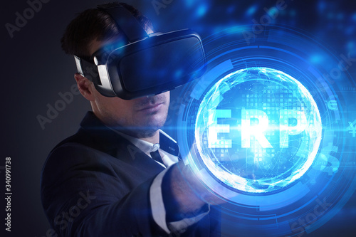 Business, Technology, Internet and network concept. Young businessman working on a virtual screen of the future and sees the inscription: ERP