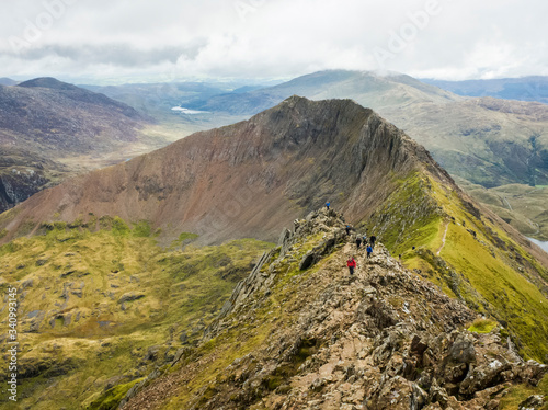 Snowdonia, Wales UK- hikers on Crib Goch, a famous knife edged ridge line route to the summit of Mount Snowdona