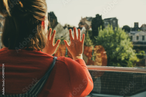Woman looking through the window with the hands leaning on top