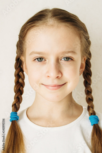 Portrait of a beautiful 9-10 years old girl with blond hair.