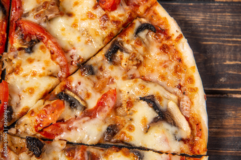 Pizza with mushrooms and chicken on a wooden table. Pizza with mushrooms and chicken on a wooden table.