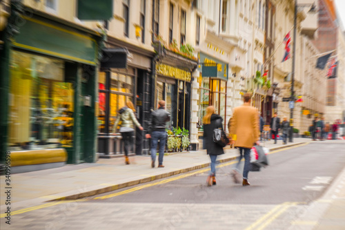 People walking on busy city shopping street