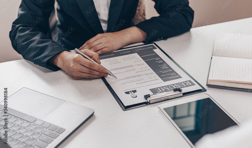 Employer or HR department is reading the resume and interviewing the ability of new employees, Employer is selecting job applicants, Employment and Recruitment Concept. Employer or HR department is reading the resume and interviewing the ability of new employees, Employer is selecting job applicants, Employment and Recruitment Concept.