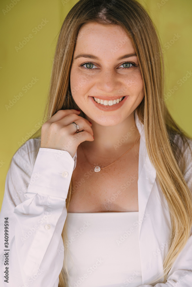 Headshot Portrait of happy girl with freckles smiling looking at